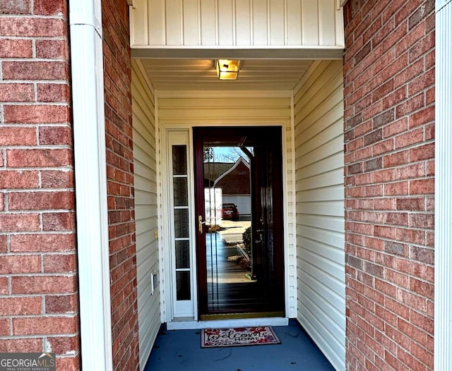 property entrance featuring brick siding