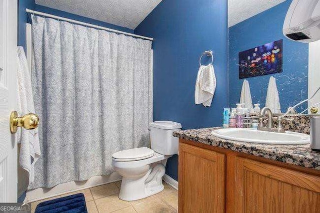 bathroom featuring vanity, tile patterned floors, toilet, and a textured ceiling