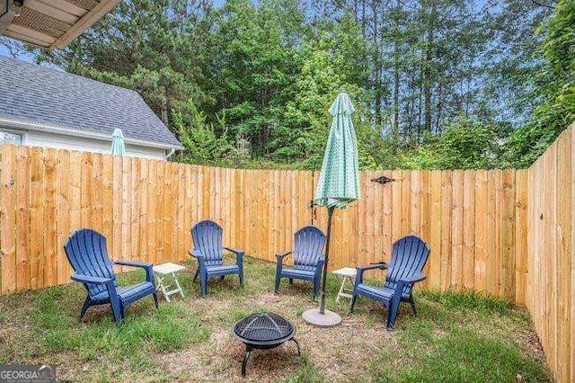 view of yard with an outdoor fire pit