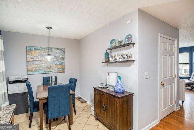 dining space featuring a textured ceiling