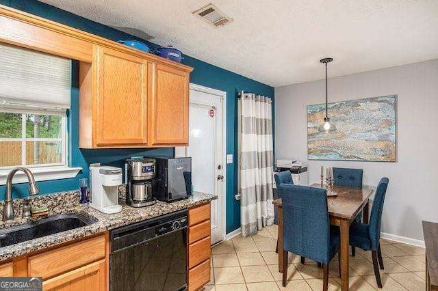 kitchen featuring sink, black dishwasher, light stone countertops, a textured ceiling, and decorative light fixtures