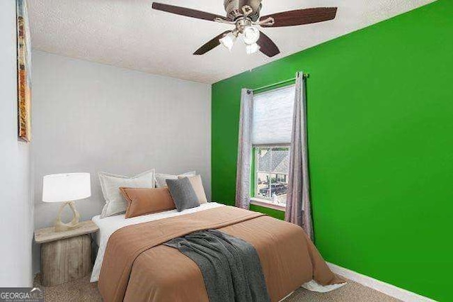 bedroom featuring ceiling fan, carpet, and a textured ceiling