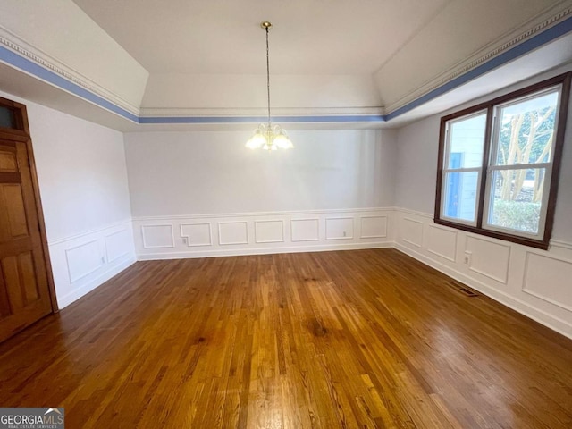 unfurnished dining area featuring dark wood-type flooring and a notable chandelier