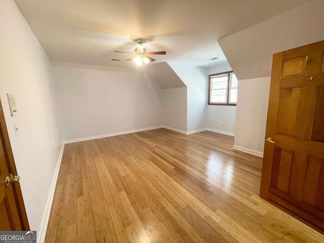 additional living space with ceiling fan and light hardwood / wood-style flooring