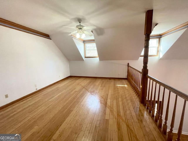 additional living space with ceiling fan, vaulted ceiling, light hardwood / wood-style floors, and a healthy amount of sunlight