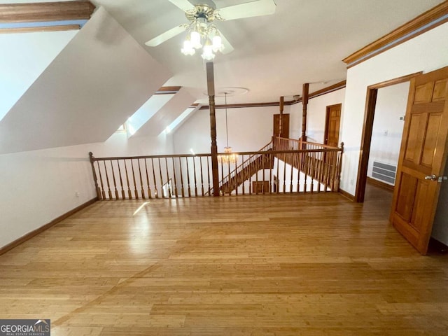 bonus room with lofted ceiling, hardwood / wood-style floors, and ceiling fan