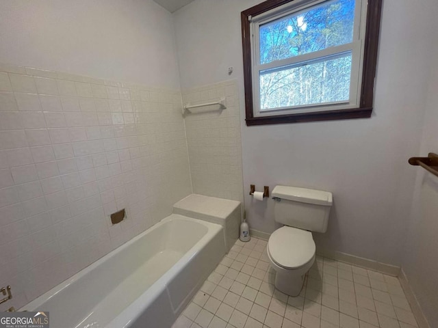 bathroom featuring toilet, tile patterned flooring, and a washtub