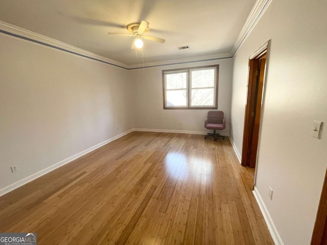 unfurnished room featuring crown molding, light hardwood / wood-style flooring, and ceiling fan