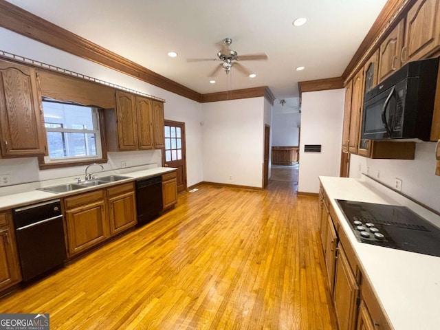 kitchen with sink, light hardwood / wood-style flooring, ornamental molding, ceiling fan, and black appliances