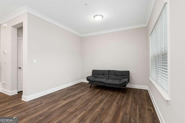 living area featuring ornamental molding and dark wood-type flooring