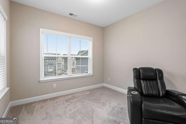 sitting room featuring light colored carpet