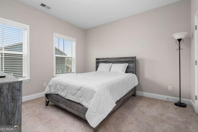 bedroom featuring light carpet