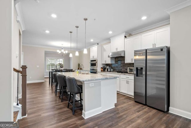 kitchen featuring appliances with stainless steel finishes, sink, a center island with sink, and white cabinets