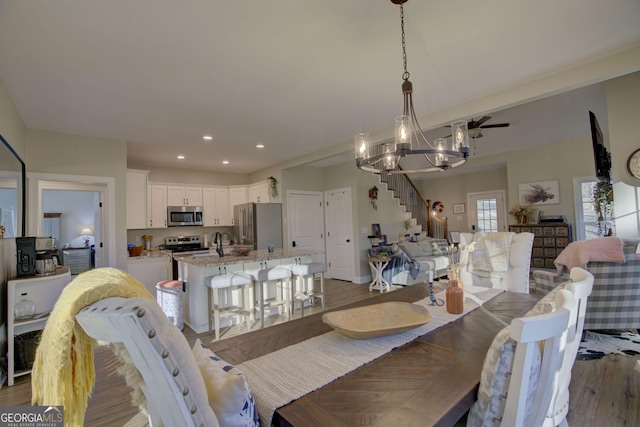 dining space with a chandelier and dark hardwood / wood-style flooring