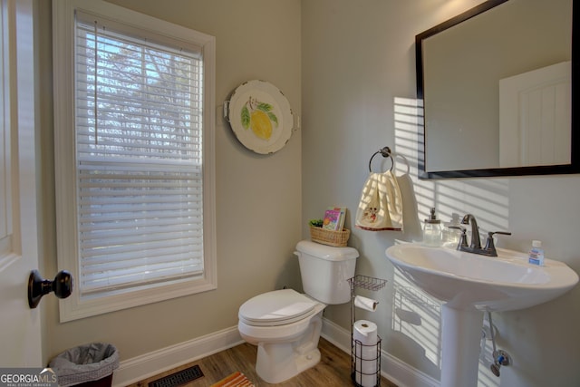 bathroom with sink, a healthy amount of sunlight, hardwood / wood-style floors, and toilet