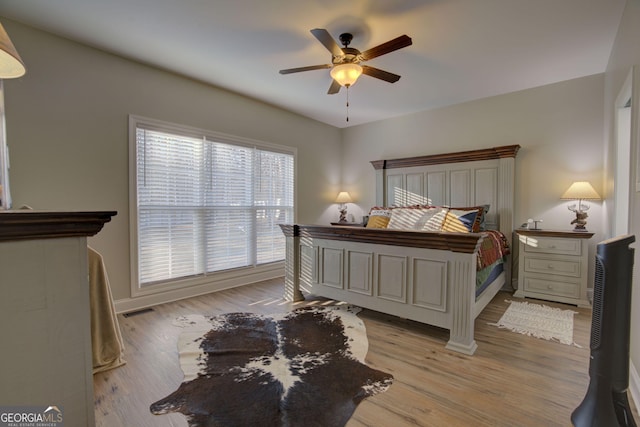 bedroom featuring light hardwood / wood-style flooring and ceiling fan