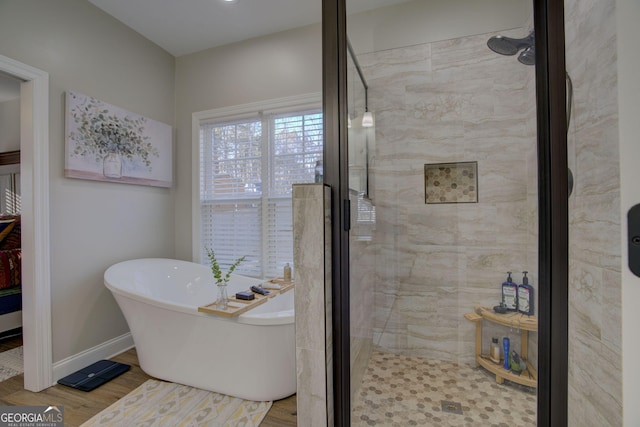 bathroom with hardwood / wood-style flooring and plus walk in shower