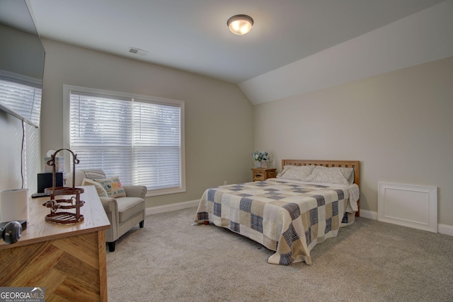 carpeted bedroom with vaulted ceiling