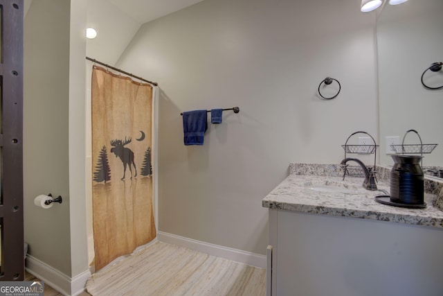 bathroom with vanity and hardwood / wood-style floors