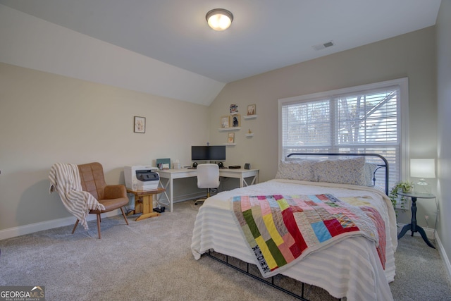 bedroom featuring light carpet and vaulted ceiling