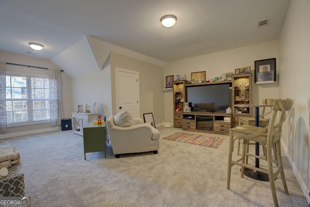 carpeted living room with vaulted ceiling