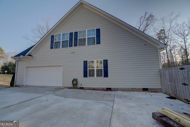 view of side of home with a garage