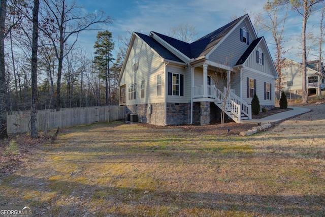 exterior space with central AC and a front yard