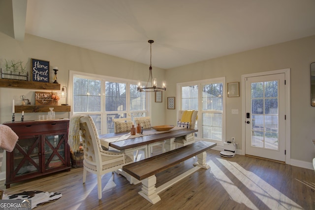 dining room featuring hardwood / wood-style floors and an inviting chandelier