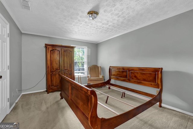 bedroom featuring ornamental molding, light colored carpet, and a textured ceiling