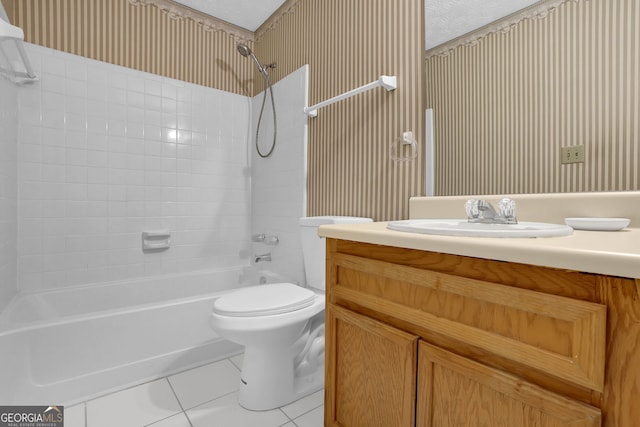 full bathroom with vanity, toilet, tile patterned flooring, and a textured ceiling