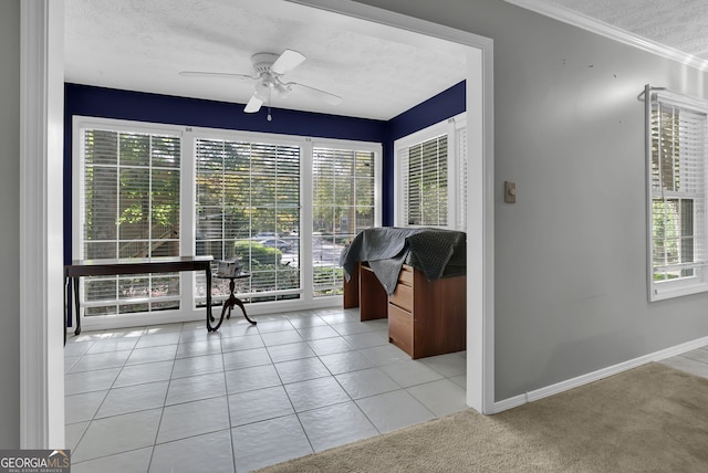 sitting room featuring ceiling fan, a textured ceiling, and light tile patterned flooring