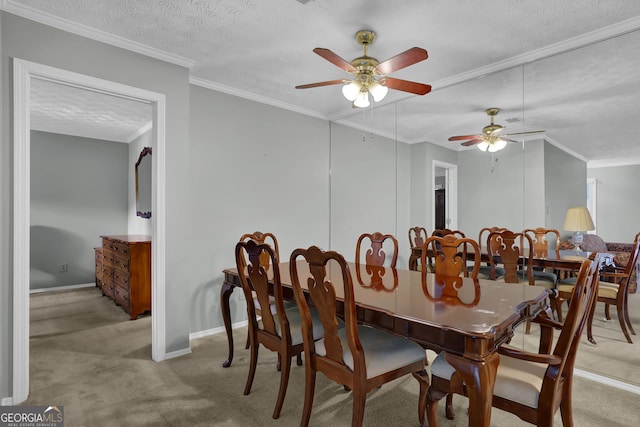 carpeted dining room with ceiling fan, ornamental molding, and a textured ceiling