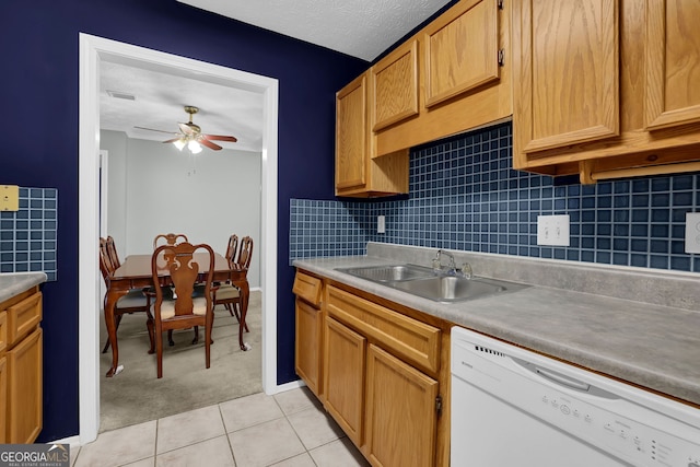 kitchen with sink, ceiling fan, white dishwasher, tasteful backsplash, and light tile patterned flooring