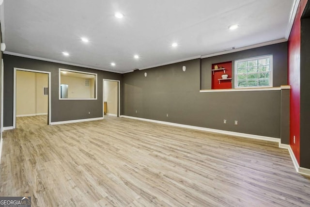 interior space featuring ornamental molding and light hardwood / wood-style flooring