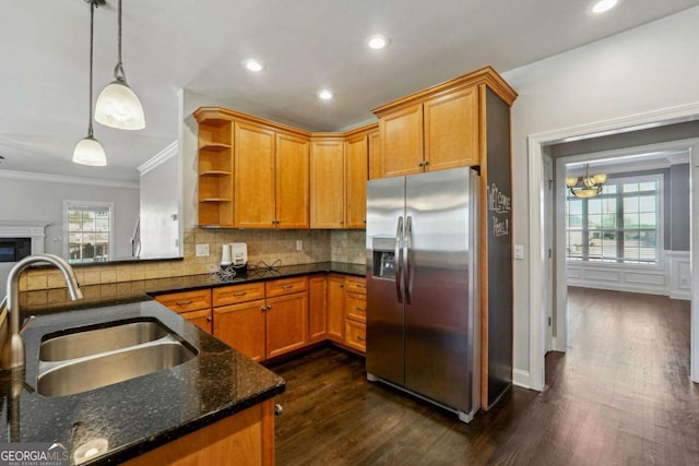 kitchen featuring sink, dark wood-type flooring, hanging light fixtures, backsplash, and stainless steel fridge with ice dispenser