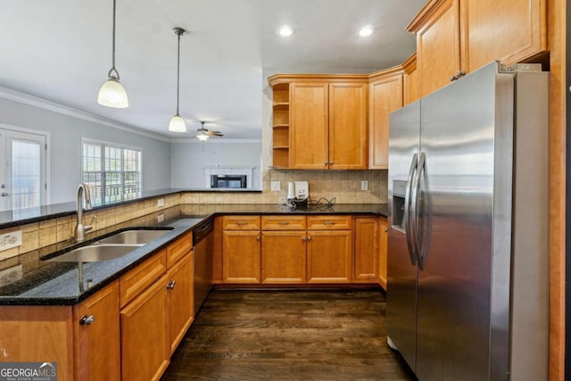 kitchen featuring sink, decorative light fixtures, ornamental molding, appliances with stainless steel finishes, and kitchen peninsula