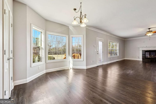 unfurnished living room with crown molding, ceiling fan with notable chandelier, and dark wood-type flooring