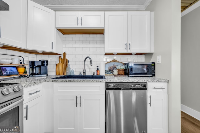 kitchen featuring sink, white cabinets, and appliances with stainless steel finishes