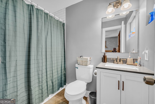 bathroom featuring vanity, a shower with shower curtain, and toilet