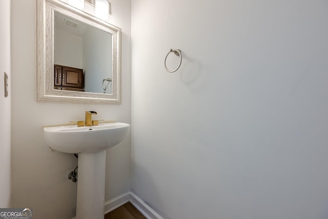 bathroom with hardwood / wood-style flooring