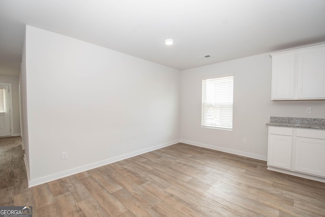 unfurnished dining area featuring light hardwood / wood-style floors