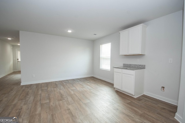 unfurnished living room with light hardwood / wood-style floors