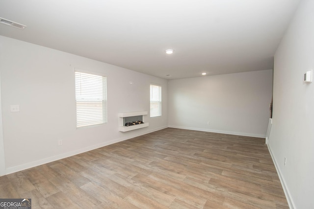 unfurnished living room featuring light wood-type flooring