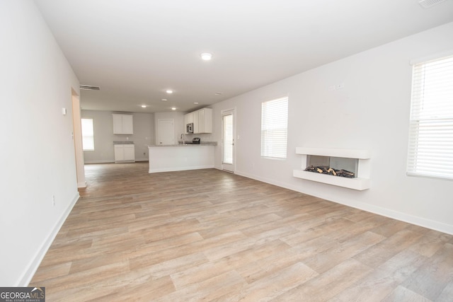 unfurnished living room featuring light hardwood / wood-style floors