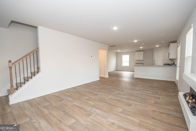 unfurnished living room featuring light hardwood / wood-style floors