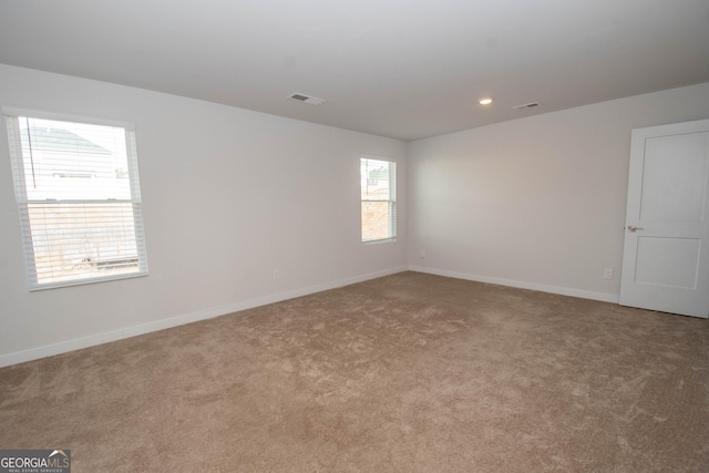 spare room with light carpet