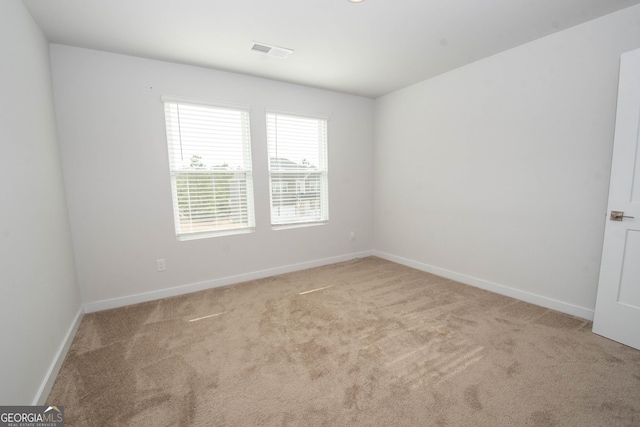 unfurnished room with light carpet