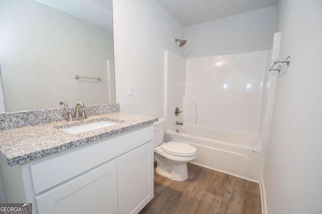 full bathroom featuring vanity, hardwood / wood-style floors, shower / tub combination, and toilet