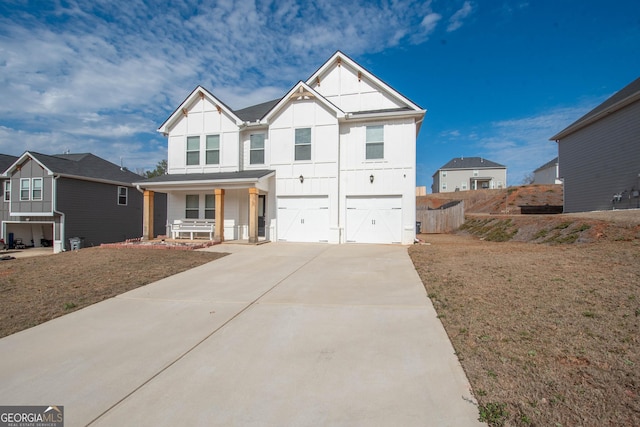 view of front of home with a garage, a front yard, and covered porch