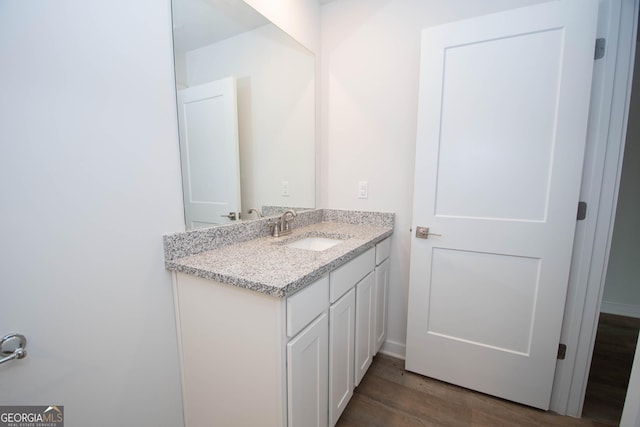 bathroom with vanity and wood-type flooring